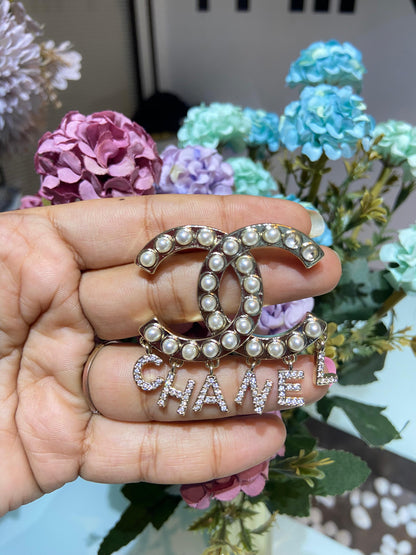 CC dangling brooch